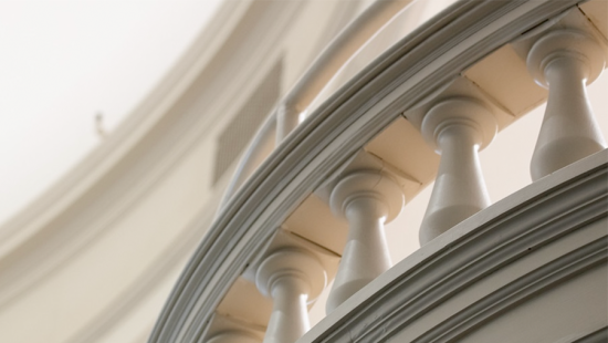 a white banister with light filtering through